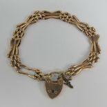 A vintage 9ct rose gold bracelet having heart padlock clasp stamped 9c, one panel a/f, 12.3g.