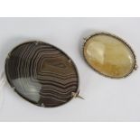 A Victorian banded agate brooch having white metal frame and measuring 3.8cm wide.