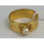 An 18ct gold wide band having raised diamond solitaire approx 0.35ct (measuring 4.