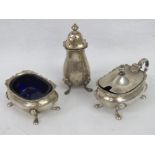 A HM silver cruet set comprising pepperette, mustard pot and salt having Bristol blue glass liner,