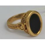 An 18ct gold and onyx signet ring,