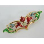 An Art Nouveau brooch of floral form having multicoloured enamelling and central seed pearl,