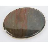 A large HM silver hardstone brooch, the oval cabachon of grey and red hues measuring 5.8 x 4.