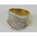 An impressive 18ct gold and diamond cocktail ring having seven separated undulating rows encrusted