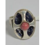 A silver ring having Maltese cross raised over purple enamel and set with pink hardstone cabachon,