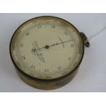 A brass cased Victorian compensated pocket barometer having broad arrow upon,