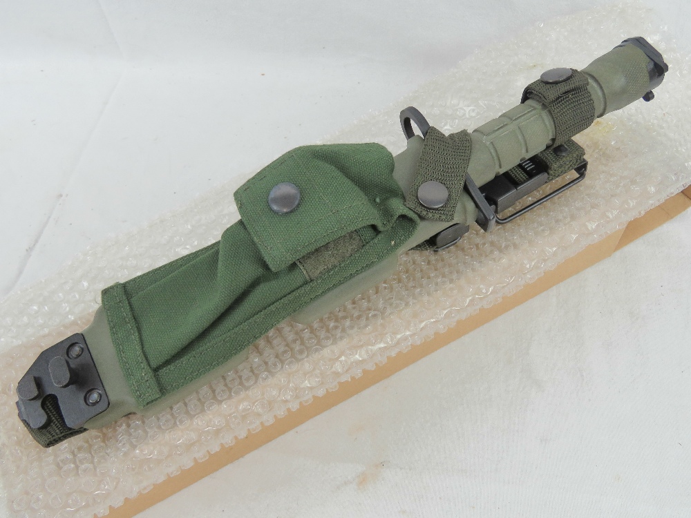 A current US military issue M9 bayonet in scabbard for the M16 rifle.