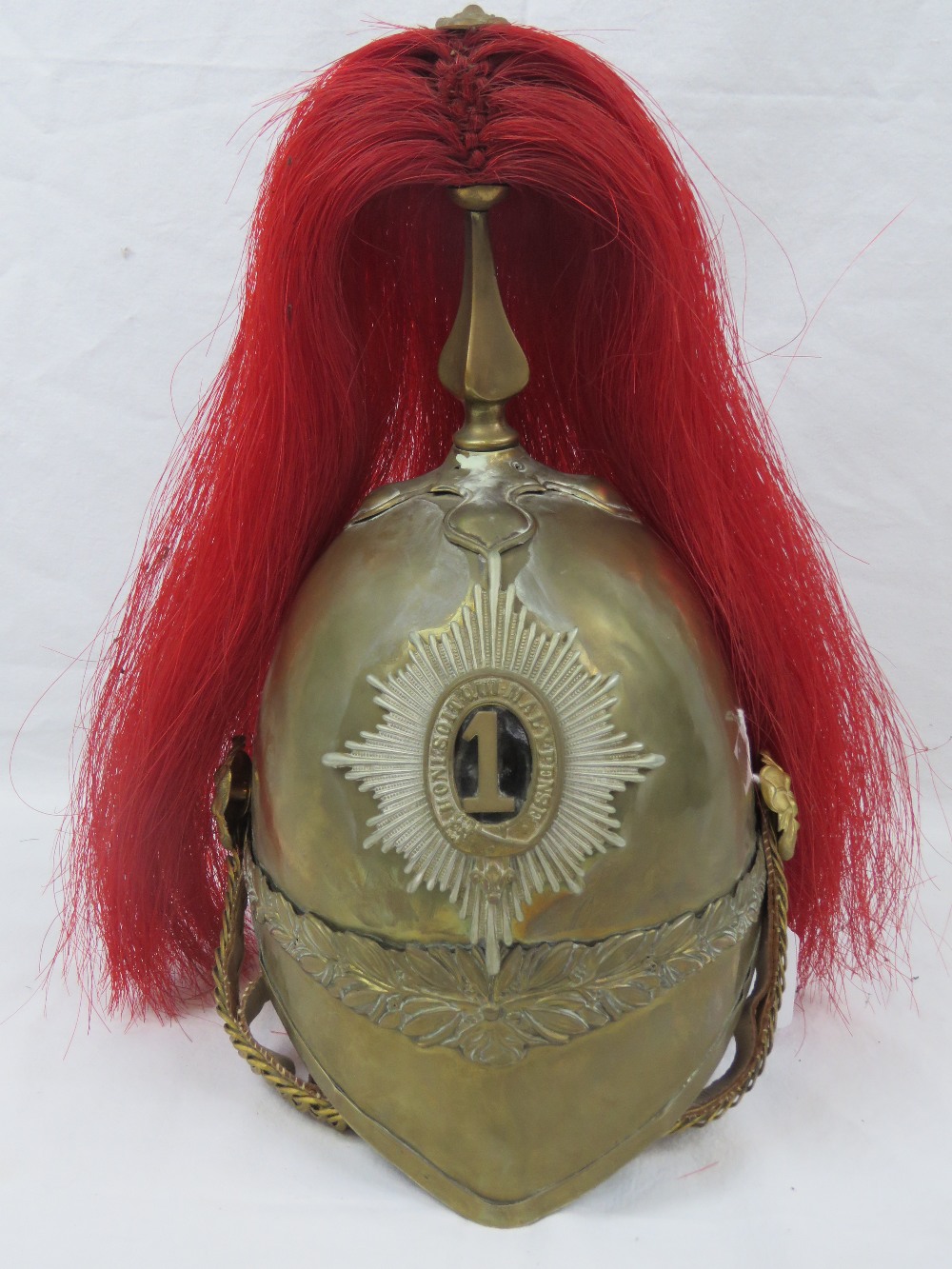 A Dragoon Guards 19th century brass helmet baring the number 1 to the shako plate,