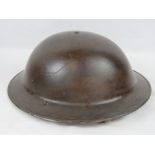 A WWII Brodie Mk1 helmet in BEF colours c1940, with liner and chin strap.