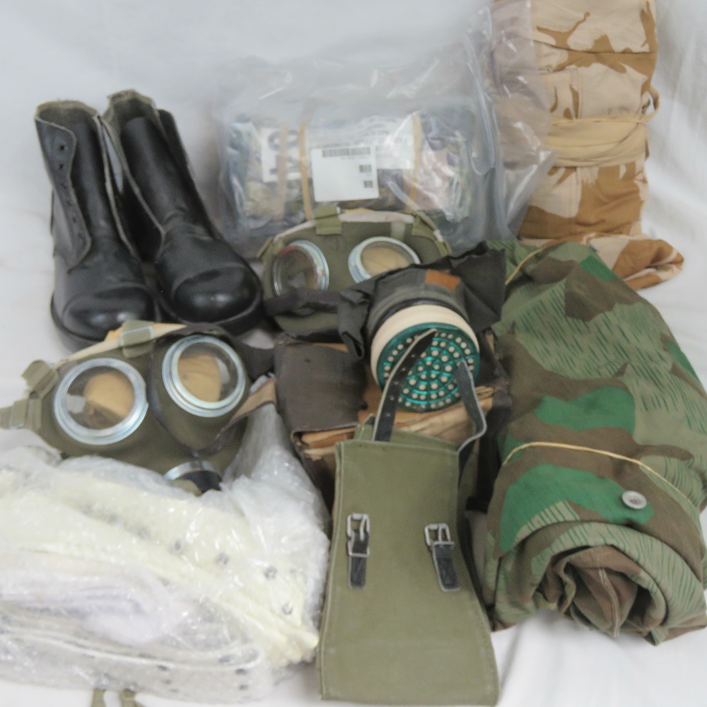 A quantity of assorted items of military interest including; boots, gas masks, webbing and poncho.