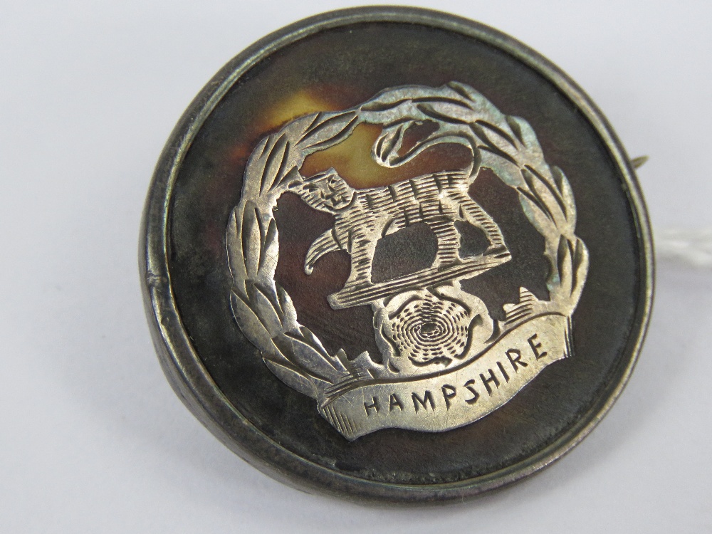 A WWI HM silver and 'tortoiseshell' regimental sweetheart brooch having inlaid emblem for the