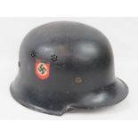 A WWII German Police helmet with swastika and two decals upon, with liner and leather chin strap.