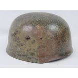 A reproduction WWII German Paratrooper Fallshirmjager helmet with liner and chin strap.