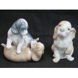 Two Nao figurines of puppies.