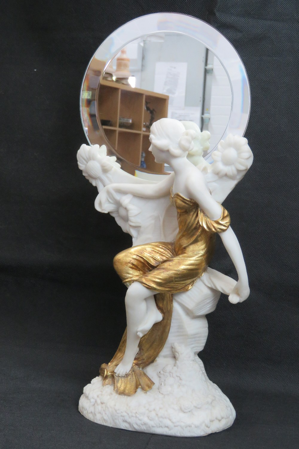 An Art Deco alabaster figurine having gi