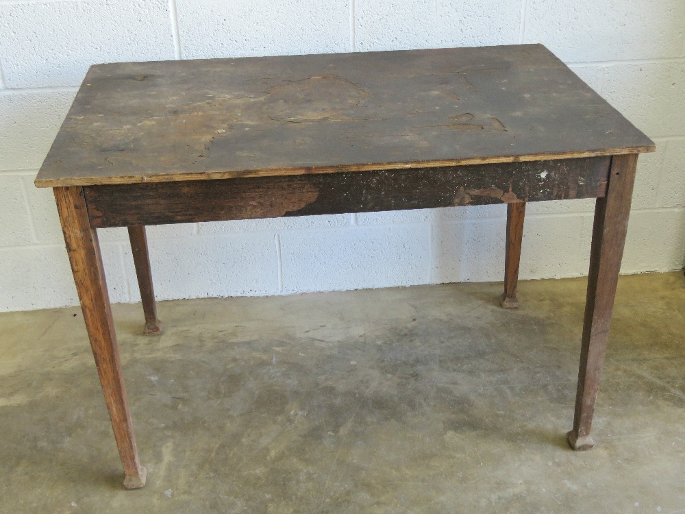 An early 20th century pine table raised