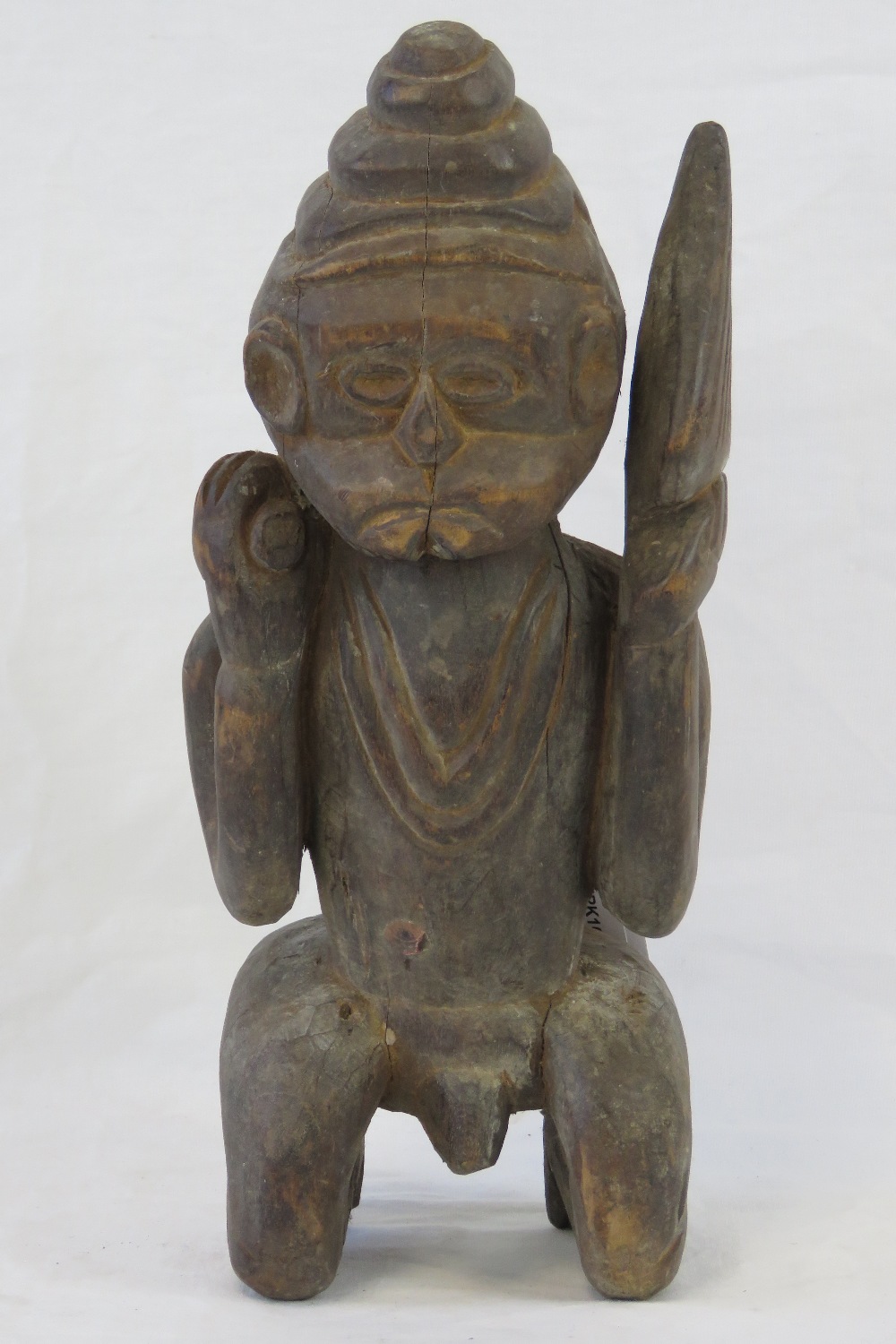 An antique carved wooden fertility figur