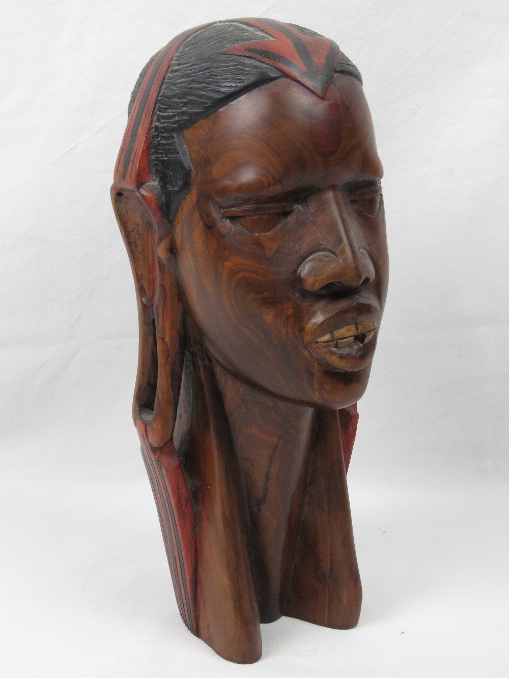 A well carved wooden bust of an African
