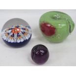 Three glass paperweights; a Langham Glas