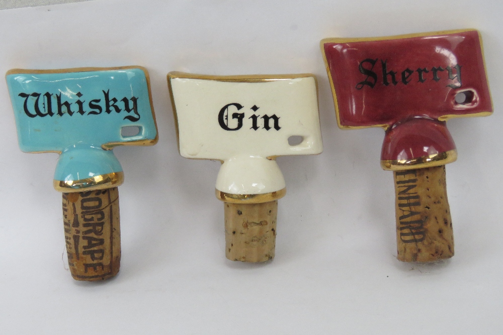 Three ceramic and cork decanter stoppers