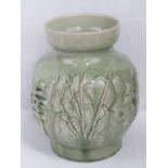 A heavy green glazed Oriental pottery va