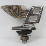 A Bentley Flying Wings B chrome plated bonnet mascot complete with stud and bolt, standing 5.