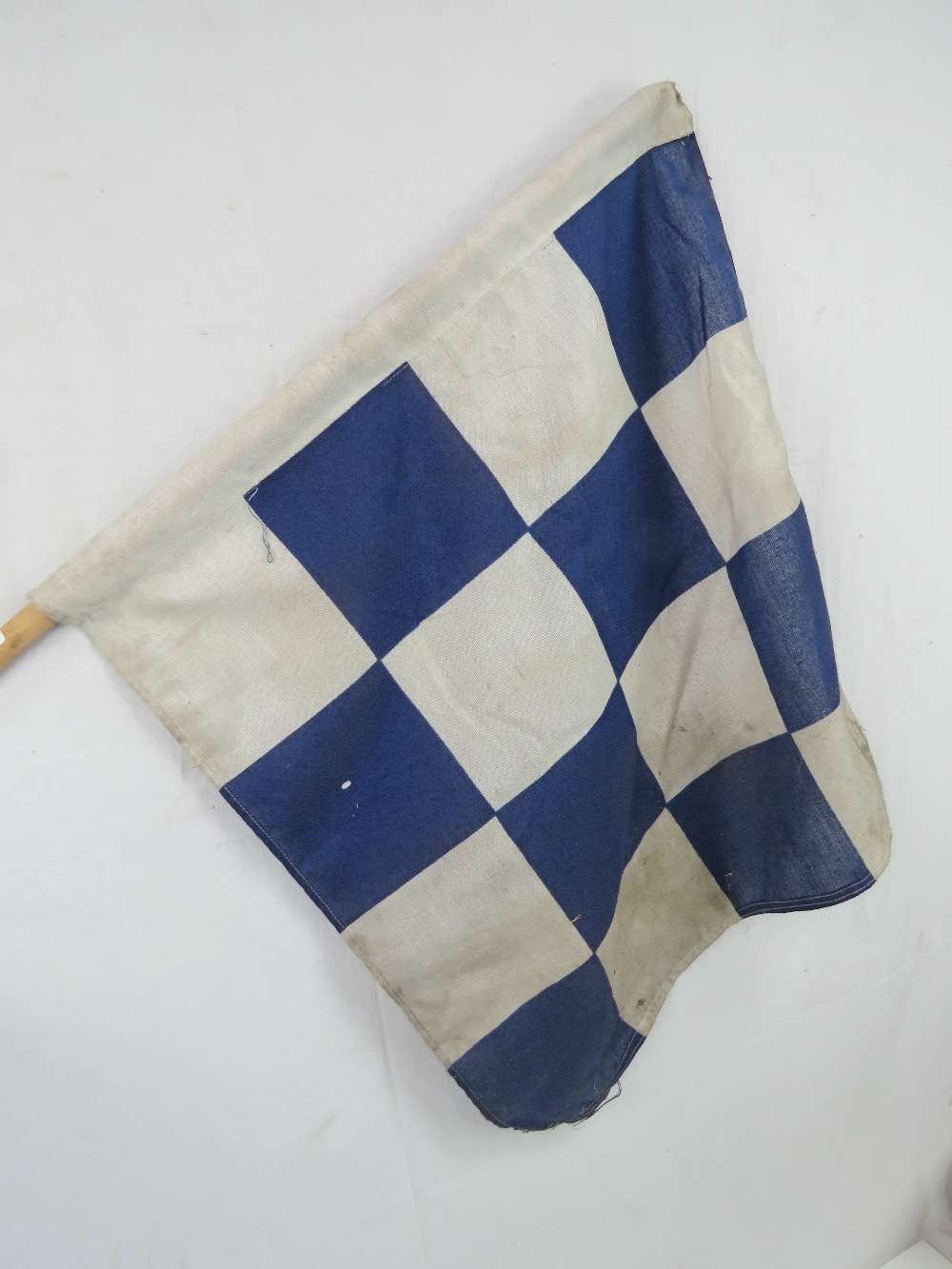 A vintage short handled square shaped checkered flag, 57 x 60cm.