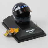A Damon Hill mini helmet dated 1997, together with a fragment of a race damaged Jordan car.