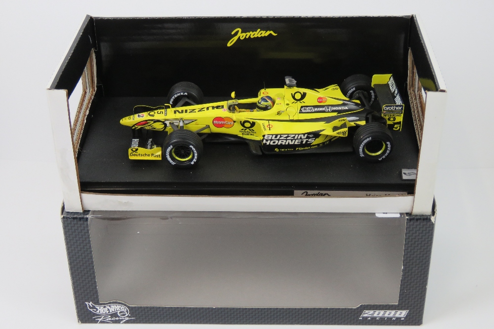 A 1:18 scale Hot Wheels Jordan F1 racing EJ10 (Heinz Harald Frentzen) in original box.