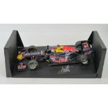 A 1:18 scale Red Bull racing F1 car signed by Sebastian Vettel 2001 25.5cm in length on base.