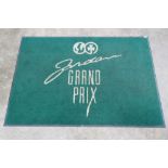 A large green ground door mat bearing Jordan Grand Prix motif upon,