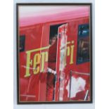 A framed and signed photographing print of Eddie Irvine leaving his motorhome in his Ferrari days,