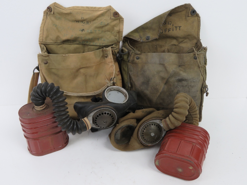Two WWII British Military issue satchel gas masks, both with filters and kit.