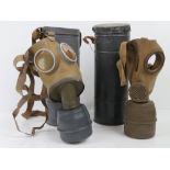 Two WWII Axis Military Issue gas masks, in original carry cans with filters.