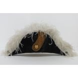 A late 19th century Naval Officers bicorn hat having gold braiding and ostrich feather decoration.