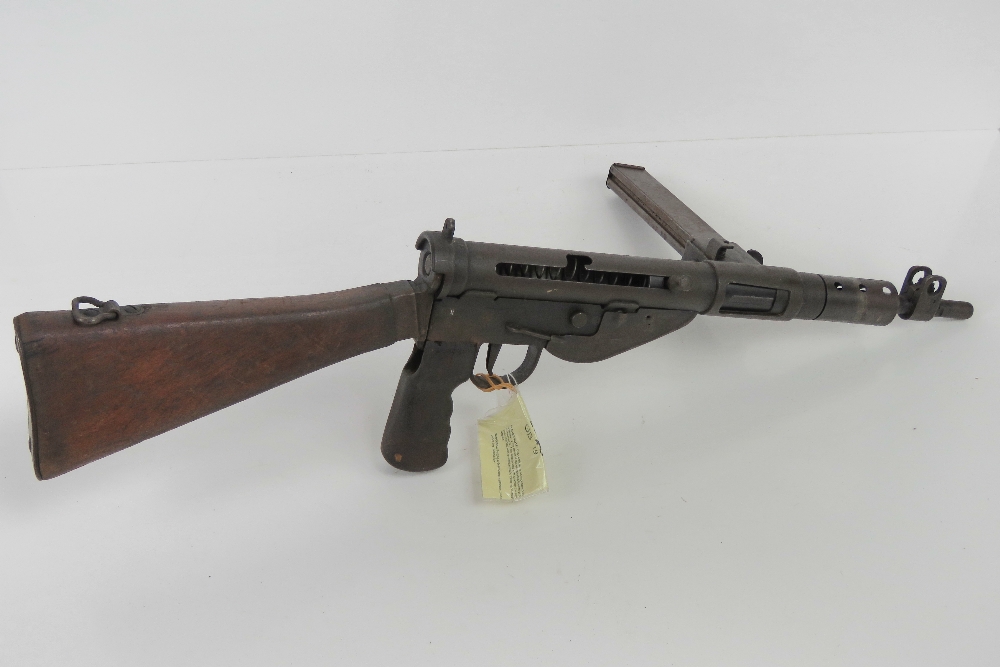 A deactivated Sten MK V 9mm sub machine gun with moving cocking handle,