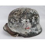 A German M35 SS helmet having two decals upon, in worn condition,