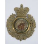 A rare pressed brass compass sleeve badge with crown over.