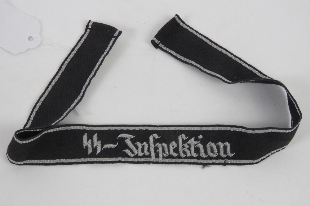 An SS Officers tunic cuff title 'SS Inspection' with SS Hersteller paper label verso,