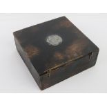 A rudimentary wooden box having inset relief medallion of a German soldier with helmet,
