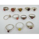 Twelve assorted silver rings including hallmarked silver carnelian ring, three goldstone rings,