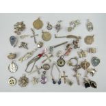 A large quantity of assorted silver and white metal pendants including;