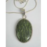 A large moss agate cabachon pendant having silver mount and silver snake link chain, pendant 5.