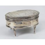 A HM silver jewellery casket raised over four legs,