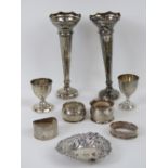 Four assorted HM silver napkin rings together with a HM silver egg cup and a HM silver pierced