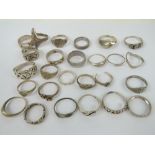 Twenty-six assorted silver rings including a Celtic knot style ring stamped 925,