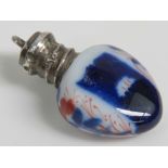 A miniature ceramic perfume bottle/pendant, indistinct hallmarks to top, 3cm in length.