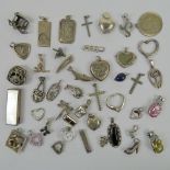 A large quantity of assorted silver and white metal pendants including a St Christopher pendant 2.