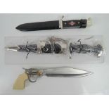 Two reproduction WWII German daggers; on