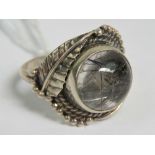 A silver and crystal ring of floral form